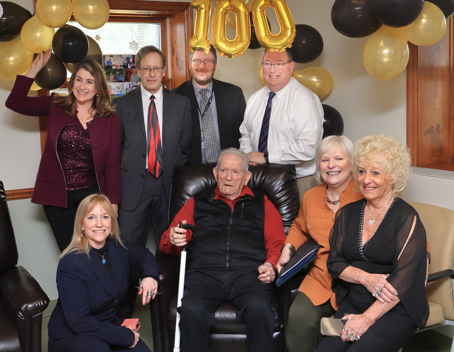 Raymond “Ray” Naholnik posed for photos with his three daughters and local officials at the celebration of his 100th birthday at the Adult Daily Living Center in Hawley, PA. Pictured are, in front: Sherrie Miller, left; Raymond; Jeannie Torrick; and Sandy Culp. In the back row are pictured PA Sen. Rosemary Brown, left; Hawley mayor John Nichols; Wayne County chief clerk Andrew Seder; and PA Rep. Joe Adams.